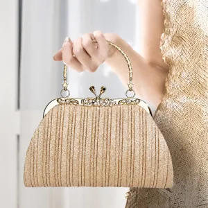 Elegant gold pleated evening dinner bag with rhinestone metal frame for women parties.