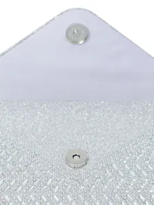 Close-up detail of silver rhinestone evening bag interior clasp, glitter clutch accessory.