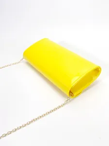 Yellow patent leather envelope crossbody bag detail with golden chain strap for women.