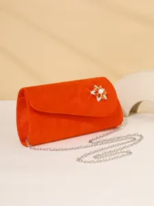 Orange velvet evening clutch bag with sparkling rhinestone pearl flower brooch and chain.