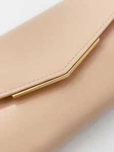 Close-up detail of nude patent leather envelope clutch bag with elegant gold metal accent bar.