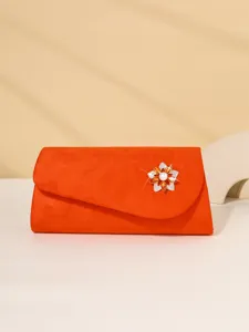 Elegant orange evening clutch bag featuring a dazzling crystal flower brooch detail for women.