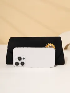 Stunning black velvet evening bag with sparkling rhinestone sunflower brooch detail.