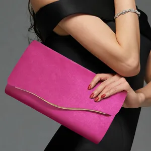 Elegant pink velvet clutch bag for women, stylish evening handbag with metal trim for parties.
