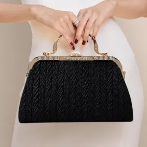 Elegant black rhinestone evening bag with gold metal handle and vintage frame for women parties.