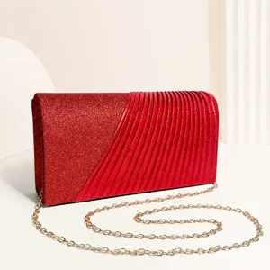 Red glitter evening bag for women with elegant pleats and gold chain strap for party.