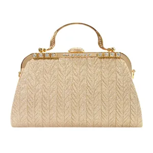 Gold glitter evening clutch bag with metallic frame, vintage handle and rhinestone decor.