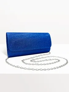 Blue glitter clutch bag detail showcasing sparkling fabric texture and silver chain strap close up