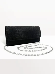 Close-up detail of the sparkling black evening clutch bag featuring a sleek silver metal chain.