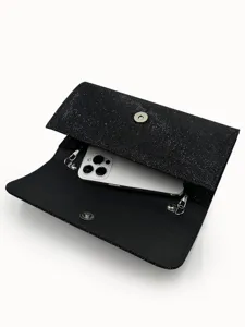 Black glitter evening clutch bag detail showing spacious interior capacity holding smartphone.