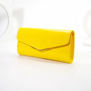 Yellow patent leather envelope clutch bag for women, stylish evening party handbag with metal clasp.