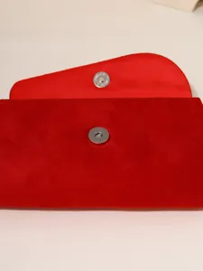Red velvet evening clutch bag with magnetic snap closure elegant women fashion accessory detail
