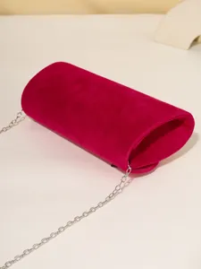Pink velvet evening bag detail showcasing soft texture and delicate silver chain strap for women.