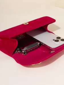 Pink velvet evening clutch bag with chain strap and spacious interior for phone and essentials.