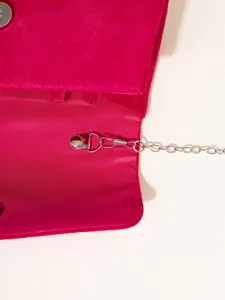 Detailed view of women evening clutch bag interior, metallic chain strap and hardware.