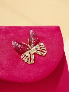 Exquisite rhinestone butterfly evening bag detail shot, elegant gold chain clutch purse.