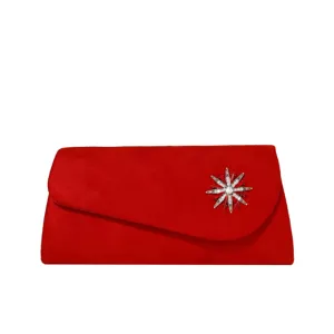 Stunning red suede evening clutch bag featuring a dazzling crystal starburst brooch accessory.