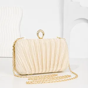 Champagne pleated evening clutch bag with crystal ring clasp and gold chain for women party.