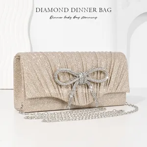 Elegant champagne gold evening clutch with sparkling crystal bow and chain strap for women.