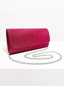 Detailed view of the bright pink sparkly glitter evening clutch bag featuring a silver chain.