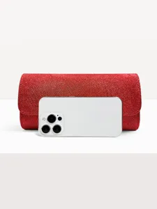 Red glitter evening clutch bag detail shot, elegant wedding party purse accessory showcase.