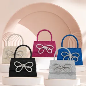 Stylish women's glitter mini handbag with sparkling rhinestone bow, elegant crossbody evening bag.