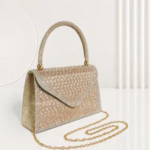 Sparkling rhinestone evening handbag with metal top handle and chain strap for parties weddings.