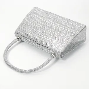 Silver rhinestone evening bag for women, elegant diamond clutch purse with round handle for parties.