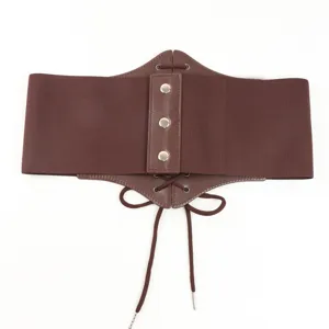 Brown vintage corset belt detail shot showing leather panel, metal snap buttons and elastic.