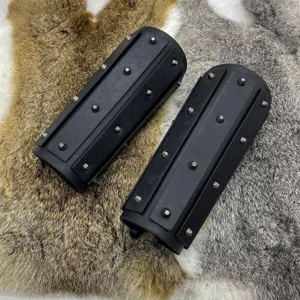 Detail shot of medieval black leather bracers with metal spikes for knight cosplay costume.