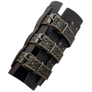Medieval leather bracer vambrace with triple buckle straps and Celtic embossed pattern details.