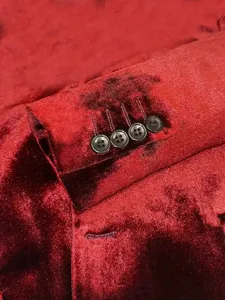 Men's luxury velvet suit jacket sleeve cuff detail, classic wine red formal blazer design.