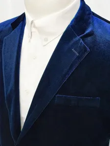 Close-up detail view of men's royal blue velvet suit jacket collar and fabric texture.