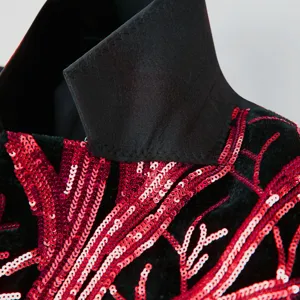 Boys sequin suit jacket detail showing red branch embroidery and black lapel collar.