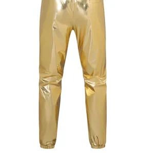 Closeup detail of shiny gold metallic pants for stage performance, elastic cuffs and bright fabric.