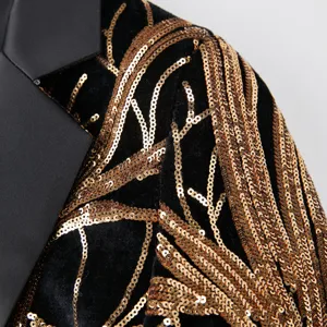 Detailed shot of boys black velvet blazer featuring luxurious gold sequin branch embroidery.