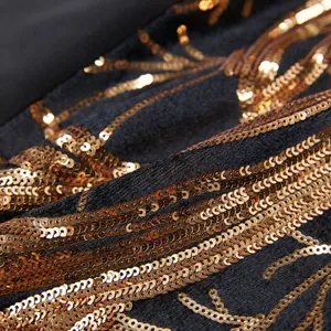 Close-up detail of boys luxury black blazer featuring sparkling gold sequin branch embroidery.