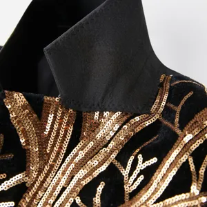 Exquisite gold sequin branch embroidery detail on black fabric, fine craftsmanship closeup view.