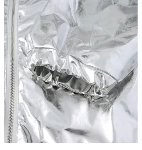 Close up detail of silver metallic jacket sleeve cuff and zipper, shiny stage performance wear.