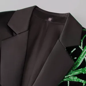 Detail shot of boys black blazer jacket with satin lapel and green sequin embroidery collar.