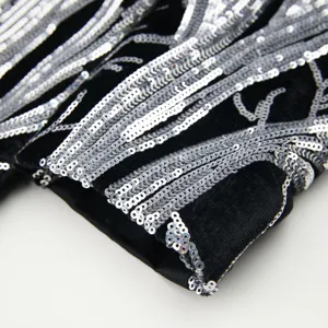 Boys black velvet sequin blazer detail close-up, trendy shiny casual suit jacket sleeve.