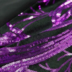 Close-up detail of black fabric with shiny purple sequin embroidery craftsmanship showcase.