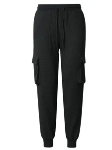 Men's black waffle knit cargo sweatpants with elastic drawstring and utility pockets.
