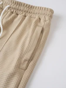 Men casual waffle knit trousers detail view, lightweight texture with comfortable elastic waistband.