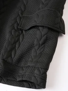 Detailed view of black jacquard knit fabric with pocket design for casual wear and daily use.