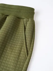 Men's waffle knit cargo sweatpants detail view, casual elastic waist and pocket design.