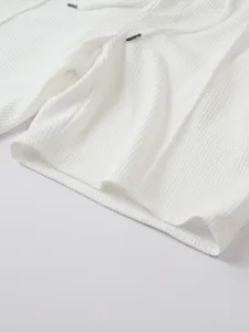 Men white waffle knit shorts detail close up fabric texture casual summer clothing feature
