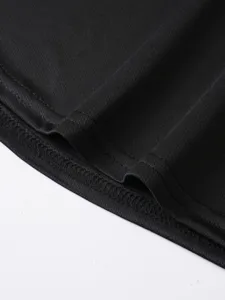 Detail view of breathable black sports tank top hem, showing fine stitching and soft fabric.