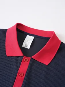 Close-up detail of mens waffle knit polo shirt with contrast color collar and buttons.