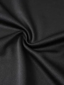 Close-up detail of black breathable athletic mesh fabric texture for fitness training apparel.